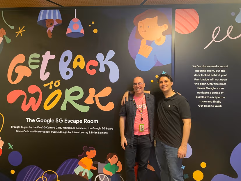 Brian and his colleague in front of their custom-designed escape room in the Google Singapore office.